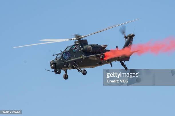 Helicopter from the Fenglei aerobatic team of the People's Liberation Army ground force performs during the 6th China Helicopter Exposition on...