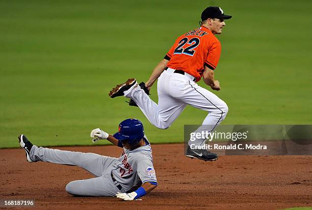 Nick Green of the Miami Marlins jumps over Ruben Tejada of the New York Mets during a MLB game at Marlins Park on April 29, 2013 in Miami, Florida.