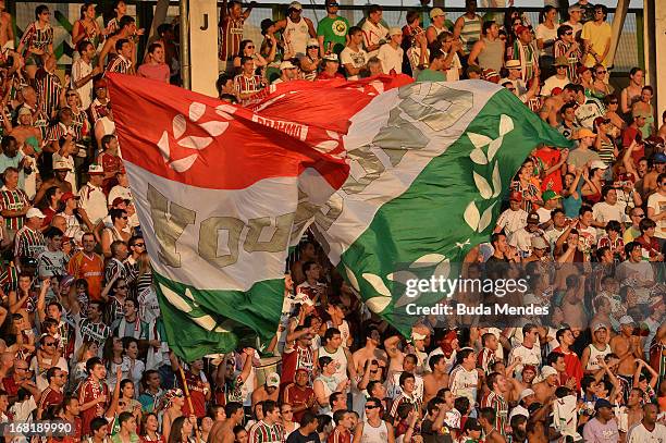 Supporters of Fluminense fcheer for their team during a match between Fluminense and Botafogo as part of Rio State Championship 2013 at Raulino de...