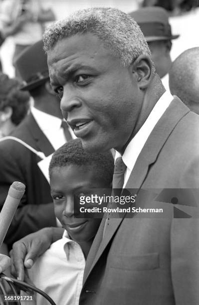 Close-up of former baseball player Jackie Robinson , with his son, at the March for Jobs and Freedom, in Washington DC, August 28, 1963.