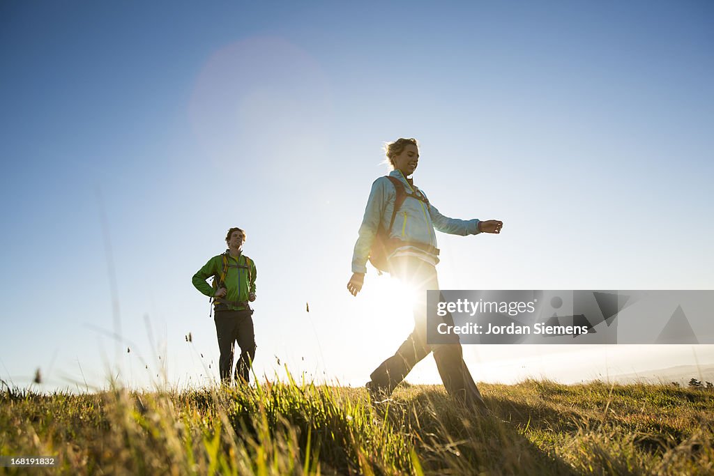 A couple hiking above the ocean.