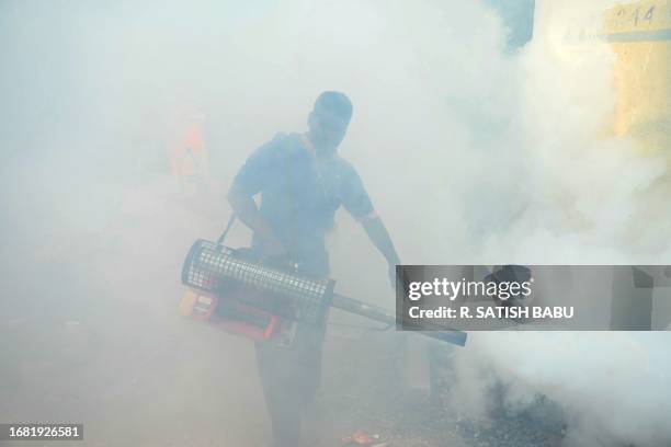 Municipal worker fumigates a locality to curb the spread of mosquitoes in Chennai on September 22, 2023.