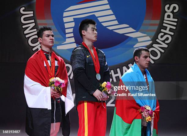 Karrar Mohammed Kadhum of Iraq A , Wenwen Huan and Firidun Guliyev of Azerbaijan A stand in the podium of the Men's 69kg Snatch during day three of...