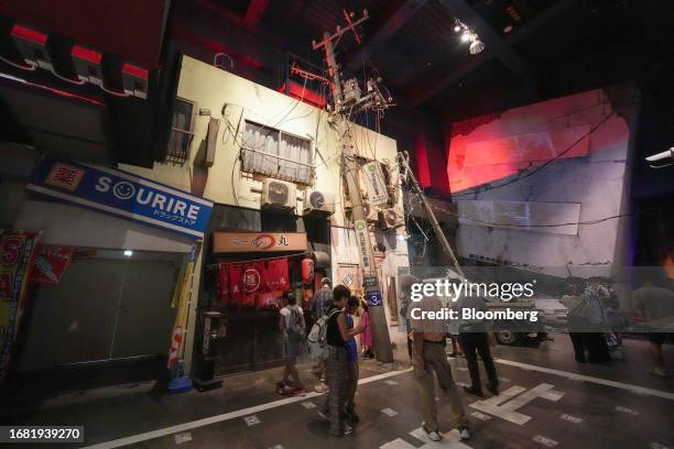 Visitors experience repeated aftershocks and learn how to evacuate in the simulation of an urban area damaged by an earthquake in the experience...
