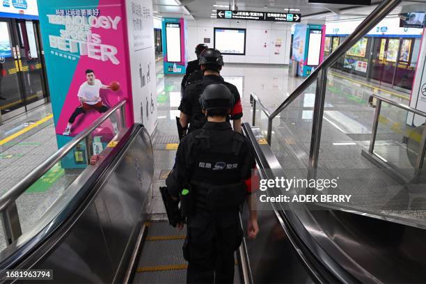 Chinese policemen patrol a subway station in Hangzhou in China's eastern Zhejiang province on September 22 on the eve of the opening ceremony of the...