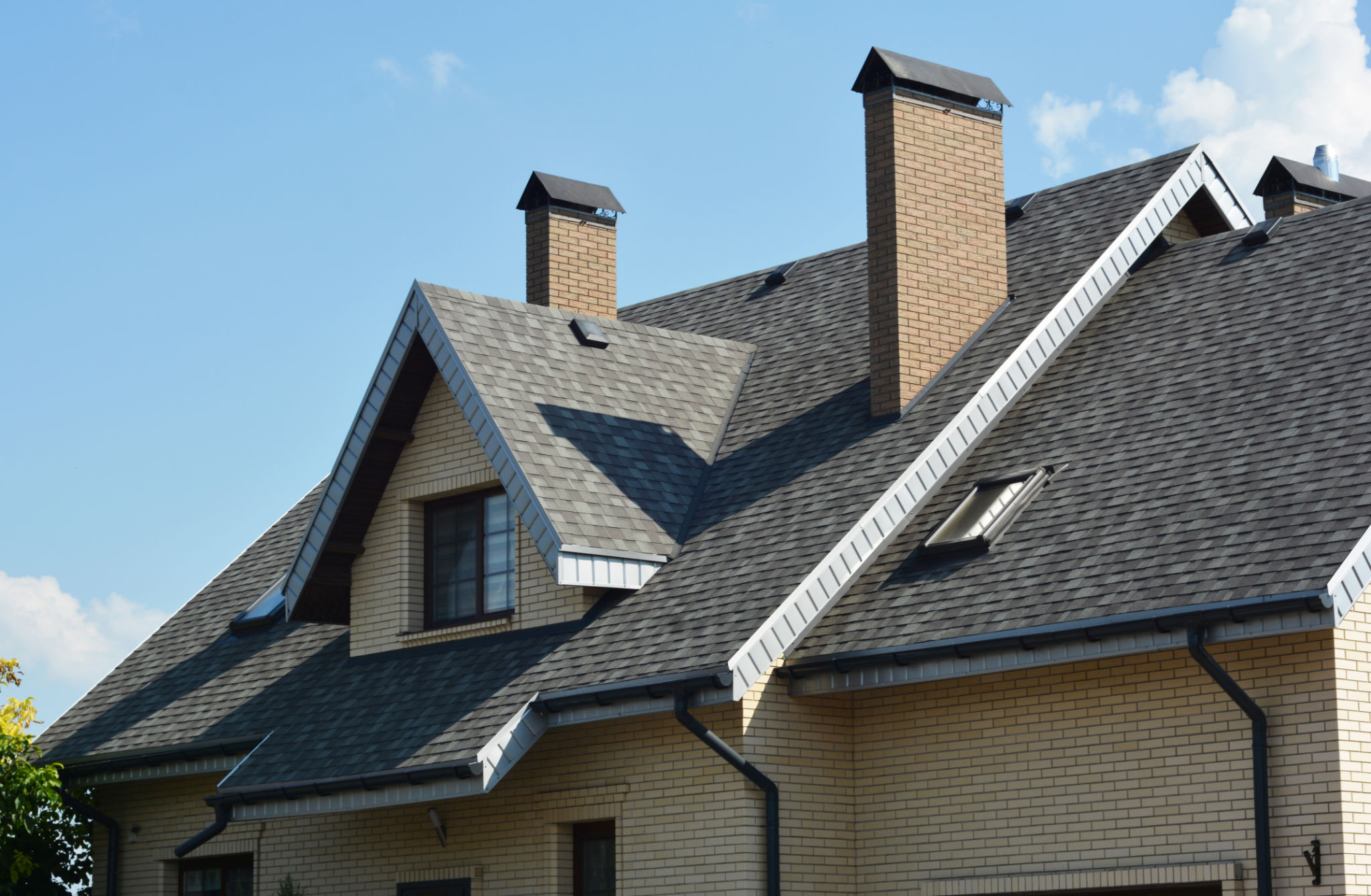 House asphalt shingles rooftop with dormer window, attic skylights, rain gutter, soffits, roof vents. House asphalt shingles rooftop with dormer window, attic skylights, rain gutter, soffits, roof vents.