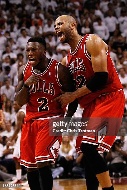 Nate Robinson of the Chicago Bulls and Taj Gibson of the Chicago Bulls celebrate after Robinson scores against the Miami Heat in Game One of the...