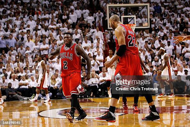Nate Robinson and Taj Gibson of the Chicago Bulls celebrate after Robinson scores against the Miami Heat in Game One of the Eastern Conference...