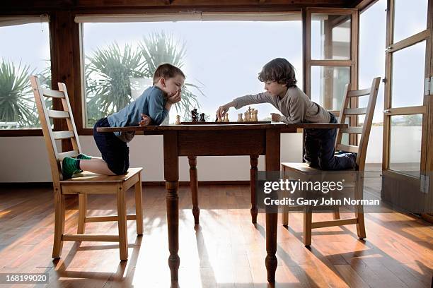 young boys playing chess - kids playing chess stock pictures, royalty-free photos & images