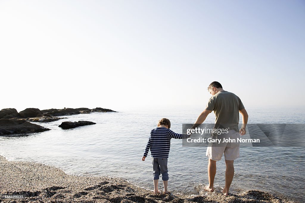 Dad and son paddling in sea