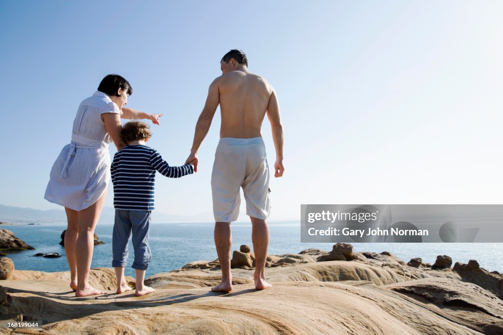 Young family exploring the beach