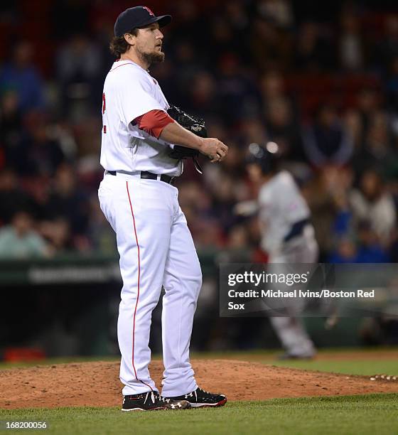 Joel Hanrahan of the Boston Red Sox looks up towards the scoreboard after allowing a home run to Brian Dozier of the Minnesota Twins in the ninth...