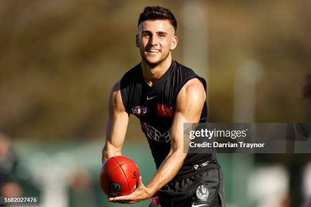 Nick Daicos of the Magpies handballs during a Collingwood Magpies AFL training session at Olympic Park Oval on September 15, 2023 in Melbourne,...