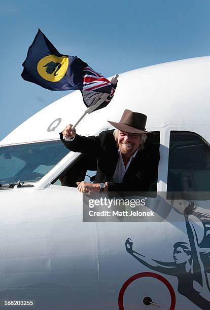 Sir Richard Branson waves a Western Australian flag from the cockpit on arrival at Perth Airport on May 7, 2013 in Perth, Australia. Virgin Australia...