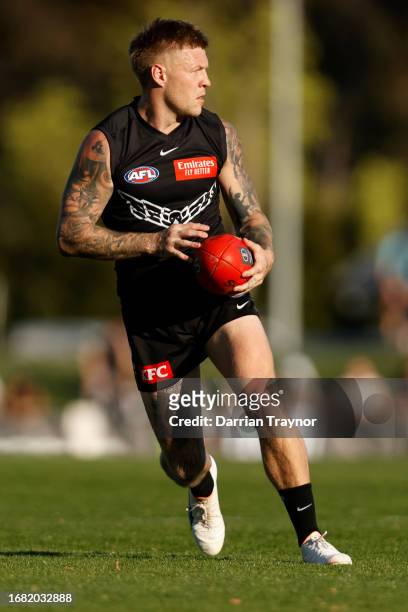 Jordan De Goey of the Magpies runs with the ball during a Collingwood Magpies AFL training session at Olympic Park Oval on September 15, 2023 in...
