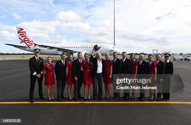 Sir Richard Branson poses with Virgin Australia flight crew at Perth Airport on May 7, 2013 in Perth, Australia. Virgin Australia purchased...