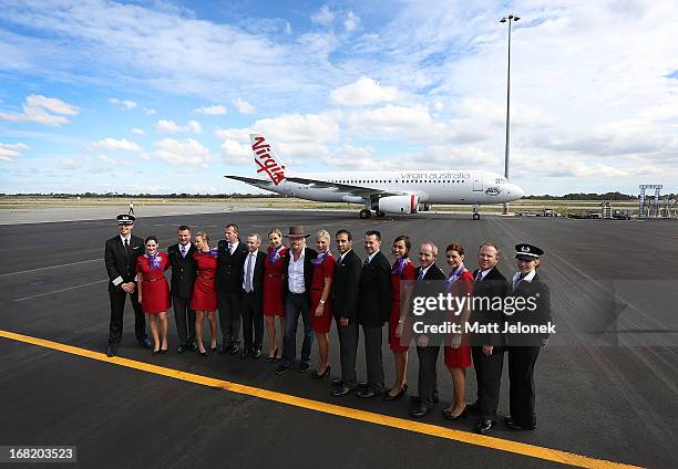 Sir Richard Branson poses with Virgin Australia flight crew at Perth Airport on May 7, 2013 in Perth, Australia. Virgin Australia purchased...