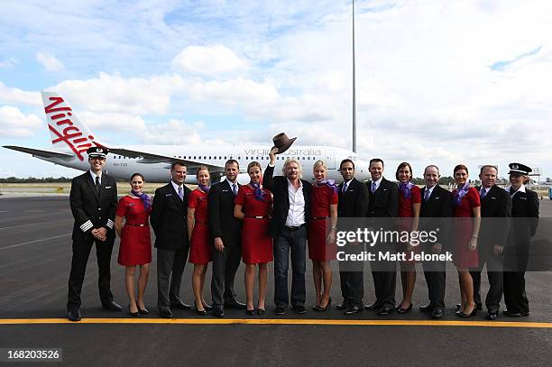 Sir Richard Branson poses with Virgin Australia flight crew at Perth Airport on May 7, 2013 in Perth, Australia. Virgin Australia purchased...