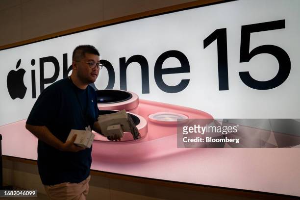 An employee at an Apple Inc. Store during the first day of sale of the iPhone 15 smartphone in Beijing, China, on Friday, Sept. 22, 2023. Apple's...