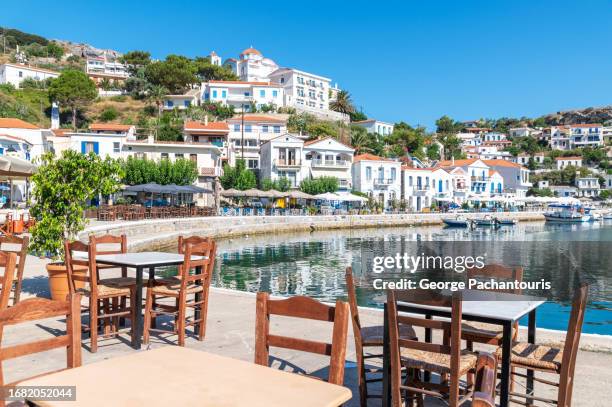 restaurant tables next to the sea on ikaria island, greece - ikaria island stock pictures, royalty-free photos & images