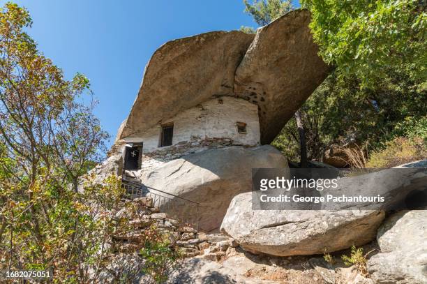 theoktisti church built under the rock on ikaria island, greece - insel ikaria stock-fotos und bilder