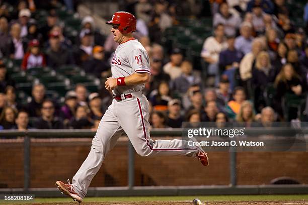 Erik Kratz of the Philadelphia Phillies scores a run against the San Francisco Giants during the ninth inning at AT&T Park on May 6, 2013 in San...