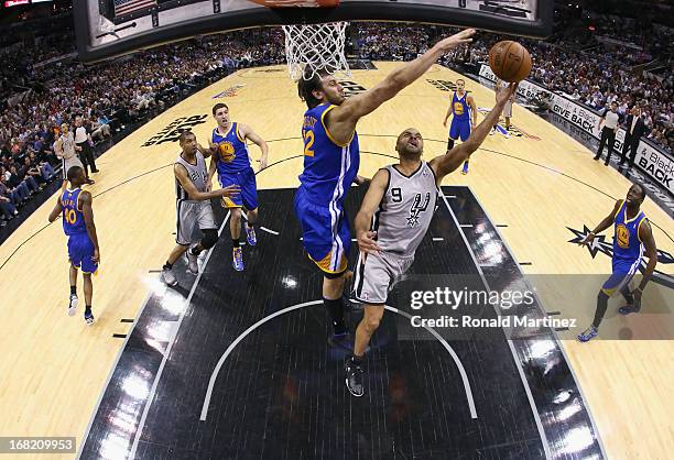 Tony Parker of the San Antonio Spurs takes a shot against Andrew Bogut of the Golden State Warriors during Game One of the Western Conference...