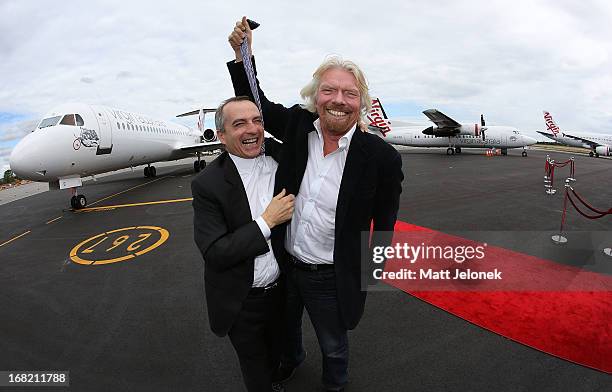 Virgin CEO John Borghetti and Sir Richard Branson pose at Perth Airport on May 7, 2013 in Perth, Australia. Virgin Australia purchased Perth-based...