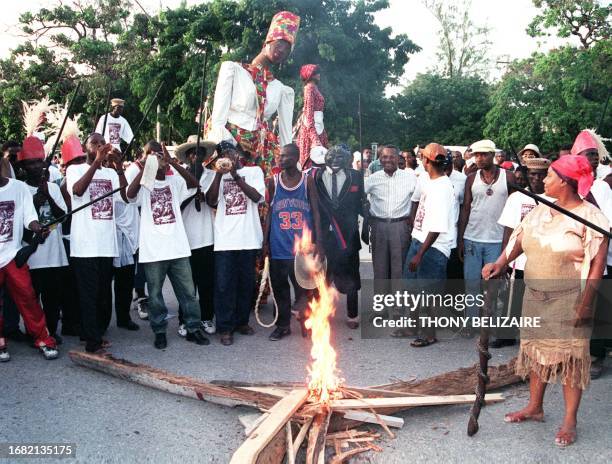 Haitian people perform a voodoo show depicting slavery during a rally organized by the UNESCO office in Port-au-Prince, Haiti, 24 August. AFP PHOTO...