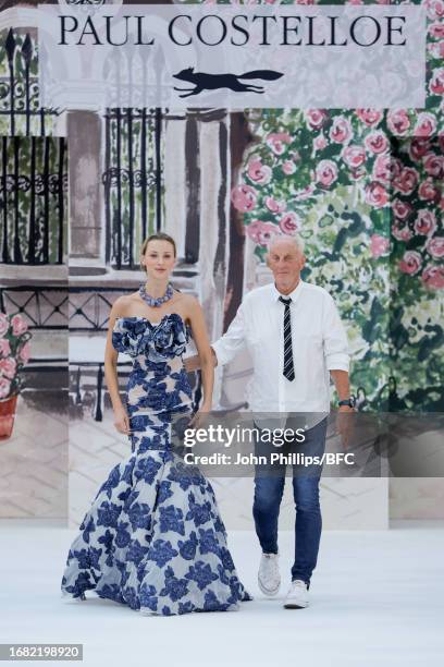 Designer Paul Costelloe and a model walk the runway at the Paul Costelloe show during London Fashion Week September 2023 at the Royal Horticultural...
