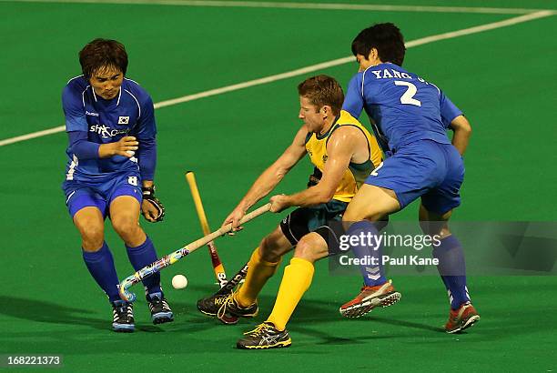 Josh Miller of Australia is challenged by Lee Seung Ill and Yang Jo Hoon of Korea during the International Test match between the Australian...