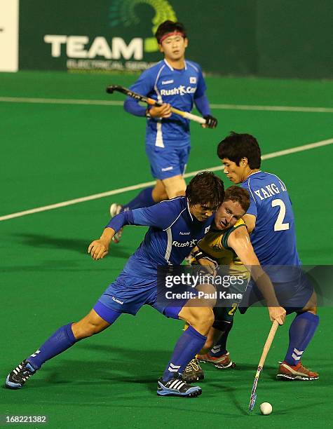 Josh Miller of Australia is challenged by Lee Seung Ill and Yang Jo Hoon of Korea during the International Test match between the Australian...