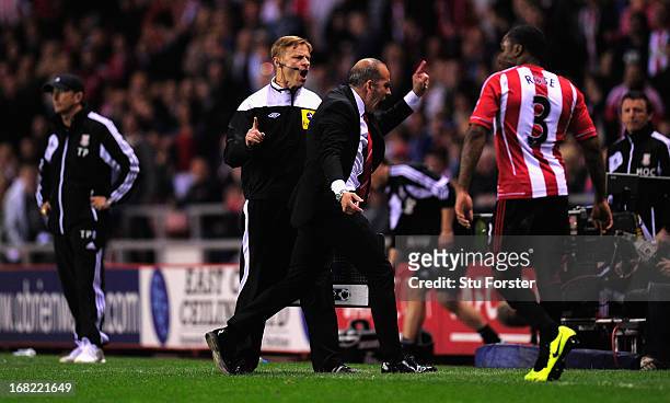 Sunderland manager Paolo Di Canio is escorted off the pitch by 4th referee Mike Jones during the Barclays Premier League match between Sunderland and...