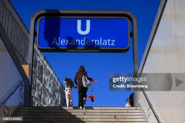 Commuters exit the AlexanderplatzU-bahn underground station, during sunny weather, in Berlin, Germany, on Thursday, Sept. 21, 2023. Extreme weather...