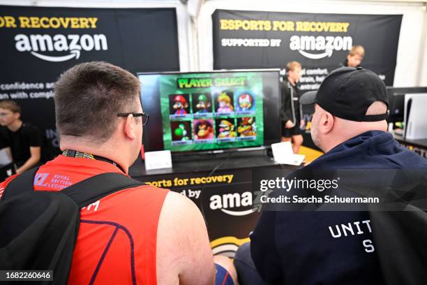 Visitors play PlayStation at the Amazon Booth at Invictus Village during day six of the Invictus Games Düsseldorf 2023 on September 15, 2023 in...