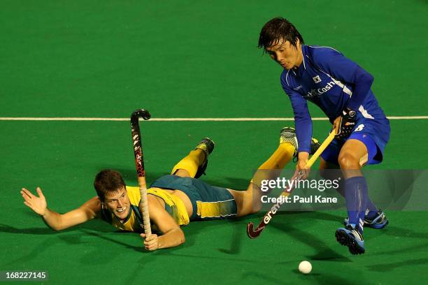 Matt Gohdes of Australia is challenged by Lee Seung Il of Korea during the International Test match between the Australian Kookaburras and Korea at...