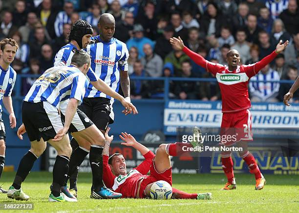 Scott McDonald of Middlesbrough goes to ground as David Prutton, Miguel llera and Anthony Gardner of Sheffield Wednesday look on during the npower...