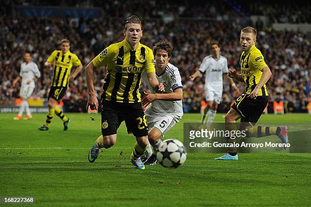 üukasz Piszczek of Borussia Dortmund runs for the ball with Fabio Coentrao of Real Madrid CF during the UEFA Champions League Semifinal second leg...