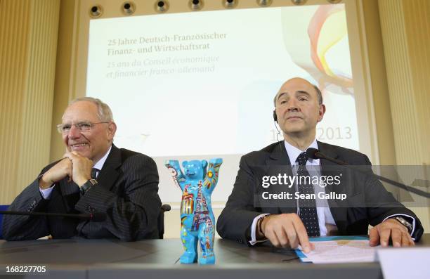 German Finance Minister Wolfgang Schaeuble and French Finance Minister Pierre Moscovici arrive to speak to the media following events marking the...