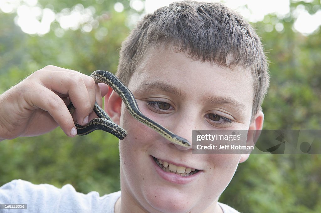 Child playing with snake