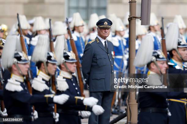 King Carl XVI Gustaf of Sweden watches during the Changing of the Guards and Choir tribute at the celebration of the 50th coronation anniversary of...
