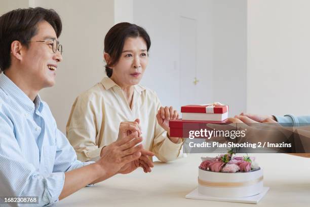 family, family month, parent's day, gratitude, smile, gift, handing over - man holding out flowers stock pictures, royalty-free photos & images