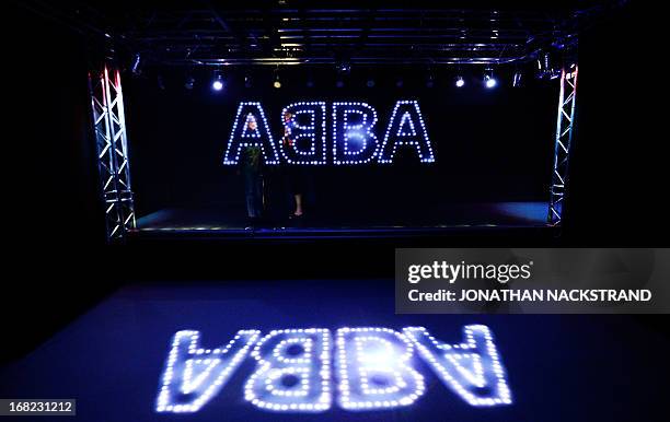 Camille BAS-WOHLERT Visitors pass by the name of Swedish disco band ABBA displayed on May 7, 2013 in Stockholm in an installation exhibited at...