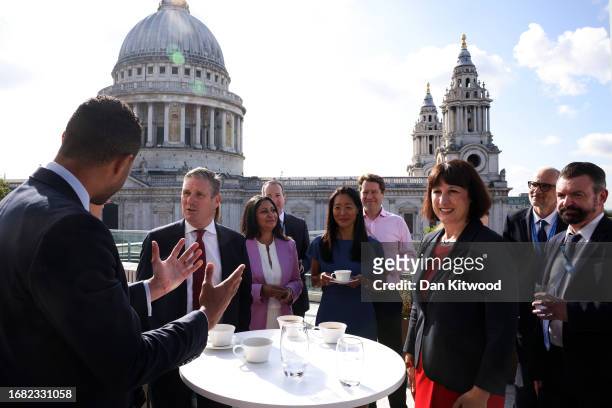 Labour leader Keir Starmer and Shadow Chancellor Rachel Reeves interact with staff during a visit to the London Stock Exchange on September 22, 2023...