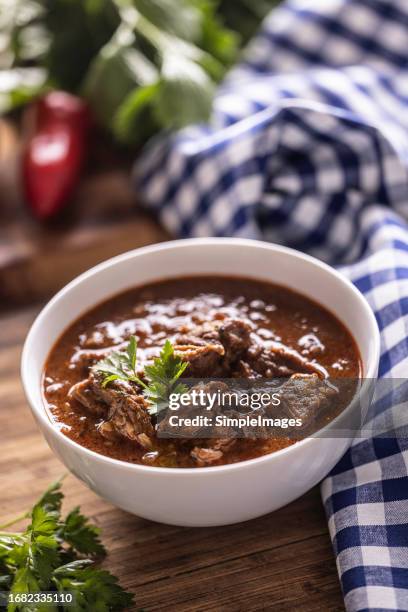 tasty goulash served with parsley herbs. - hot pot dish stock pictures, royalty-free photos & images