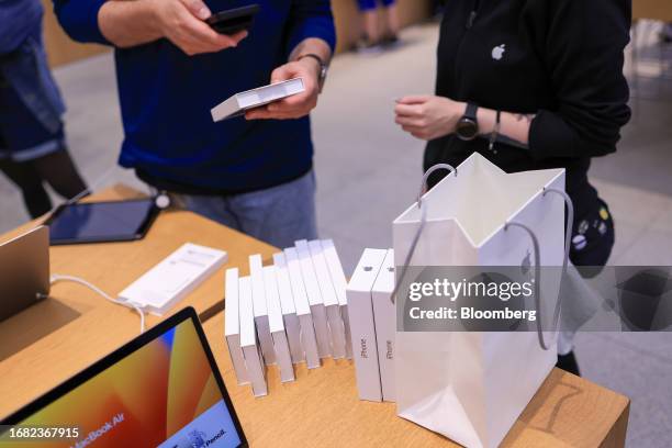 An employee scans the barcode of an iPhone 15 case at the Apple Inc. Rosenthaler Strasse store in Berlin, Germany, on Friday, Sept. 22, 2023. Apple's...