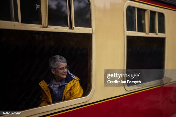 Woman looks from a carriage window as she departs from the North Yorkshire Moors Railway station at Pickering on September 15, 2023 in Pickering,...