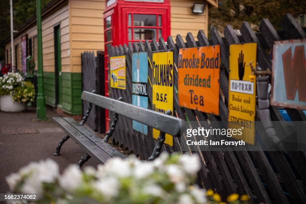 Old shop signs are displayed on a fence at the North Yorkshire Moors Railway station at Pickering on September 15, 2023 in Pickering, England. The...