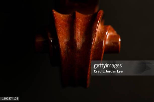 violin scroll on black background - cello scroll stock pictures, royalty-free photos & images