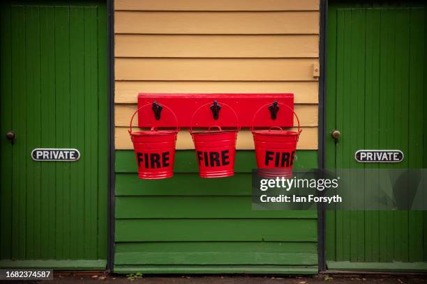 Fire buckets hang from a wall at the North Yorkshire Moors Railway station at Pickering on September 15, 2023 in Pickering, England. The Caledonian...